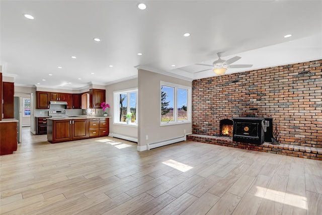 unfurnished living room featuring ornamental molding, ceiling fan, baseboard heating, light wood finished floors, and a baseboard heating unit