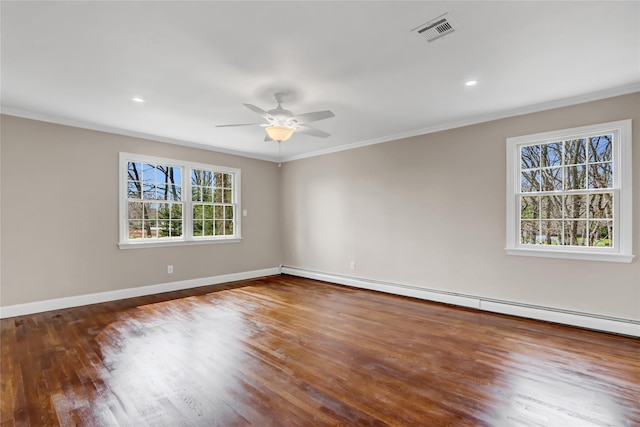 spare room featuring a ceiling fan, ornamental molding, visible vents, a baseboard radiator, and baseboards