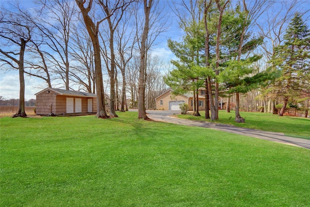 view of yard with an outbuilding and a garage