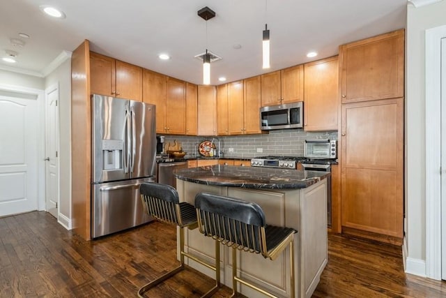 kitchen with a center island, baseboards, dark wood-style floors, and stainless steel appliances
