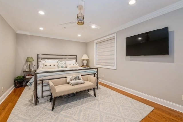 bedroom with a ceiling fan, ornamental molding, recessed lighting, wood finished floors, and baseboards