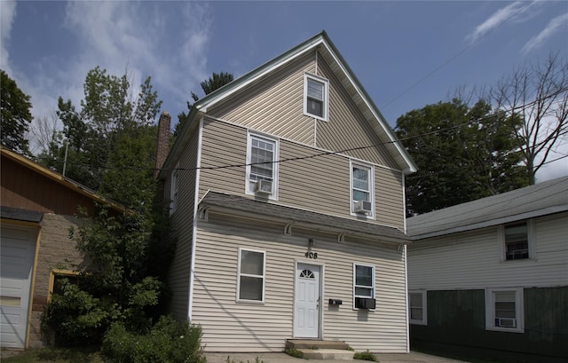 view of front of property with cooling unit and a chimney