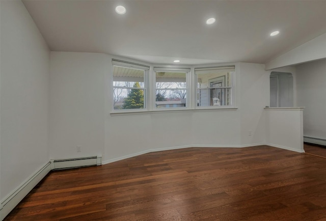 empty room featuring recessed lighting, baseboard heating, baseboards, and wood finished floors