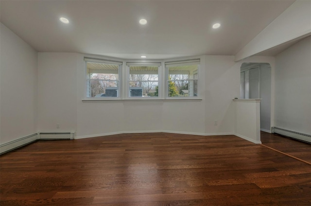 additional living space with a baseboard radiator, wood finished floors, baseboards, and recessed lighting