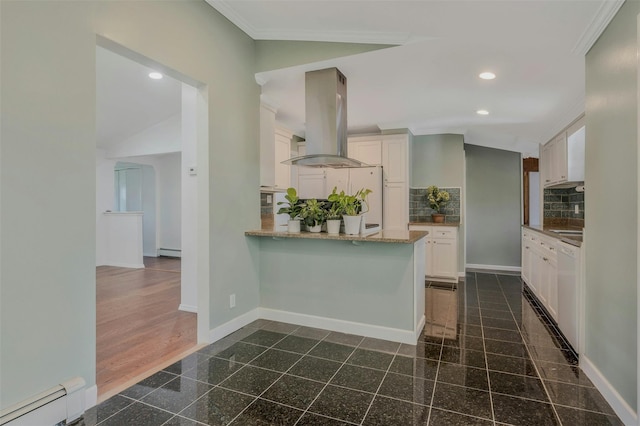 kitchen featuring granite finish floor, white cabinetry, recessed lighting, island exhaust hood, and a baseboard heating unit