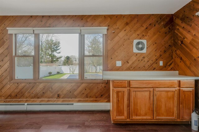 bonus room featuring visible vents, a baseboard radiator, dark wood-style floors, and wood walls