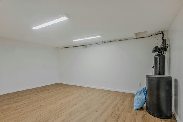 finished below grade area featuring light wood-style floors and baseboards