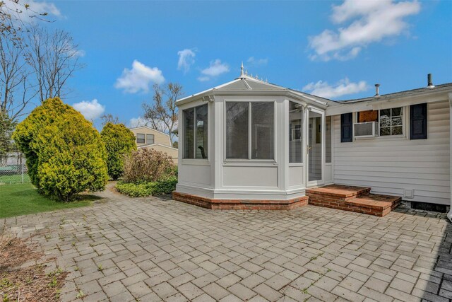 rear view of house with a patio and a sunroom