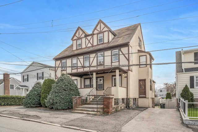 28 Greenwood Ave, Port Chester, NY 10573 - view of front facade featuring stucco siding and fence