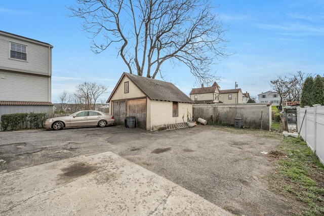 28 Greenwood Ave, Port Chester, NY 10573 - exterior space featuring a detached garage, an outbuilding, and fence