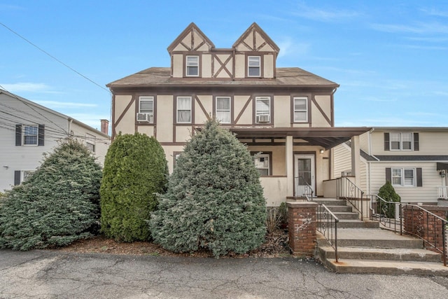 28 Greenwood Ave, Port Chester, NY 10573 - english style home featuring cooling unit, a shingled roof, and stucco siding