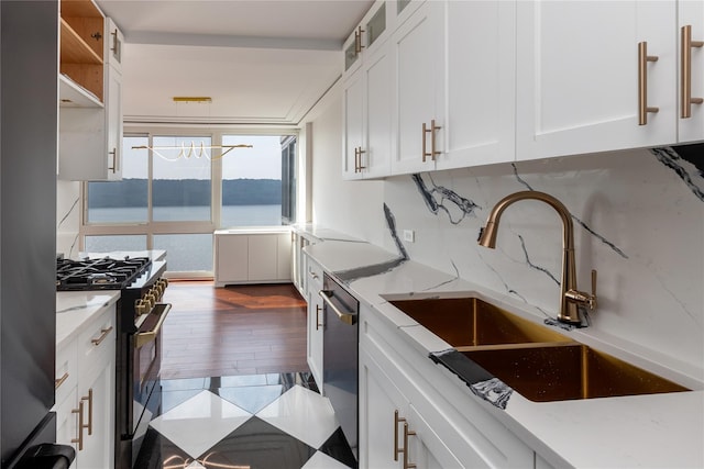 2521 Palisade Ave Unit 6A, Bronx, NY 10463 - kitchen with appliances with stainless steel finishes, white cabinets, light stone countertops, and glass insert cabinets