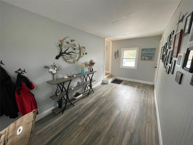 foyer entrance with baseboards and wood finished floors