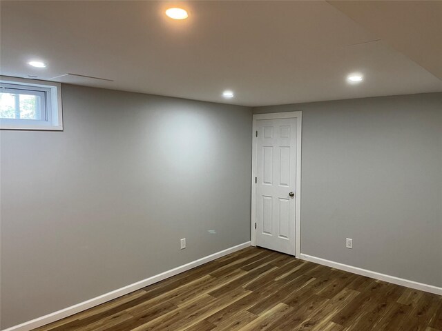 below grade area featuring dark wood-style flooring, recessed lighting, and baseboards