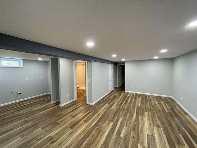 below grade area with recessed lighting, dark wood-style flooring, and baseboards