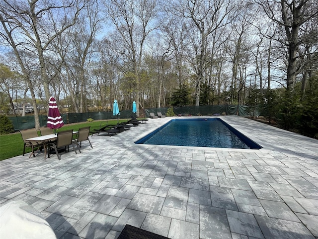 outdoor pool featuring a patio and a fenced backyard