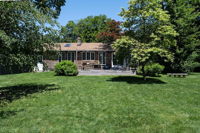 35 Turtle Cove Ln, Huntington, NY 11743 - rear view of house with a chimney, a yard, and a patio area