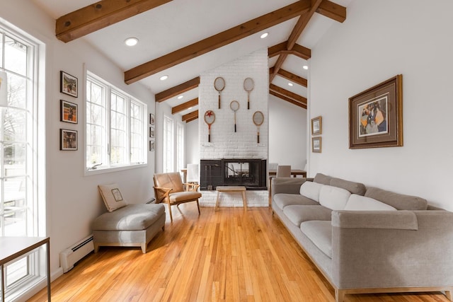 35 Turtle Cove Ln, Huntington, NY 11743 - living room with a baseboard heating unit, light wood-style flooring, a fireplace, and recessed lighting