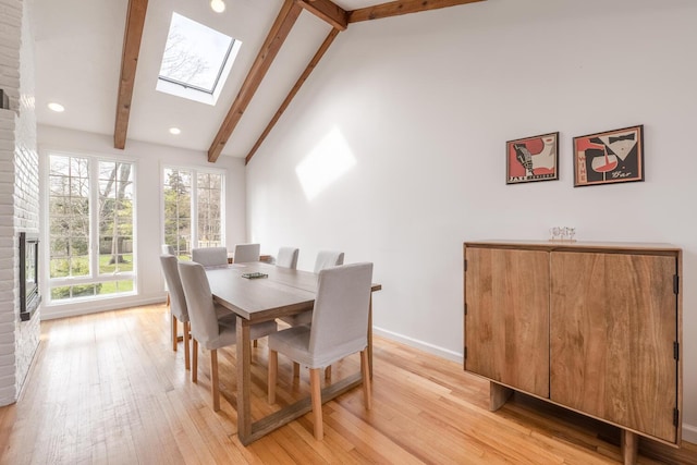 35 Turtle Cove Ln, Huntington, NY 11743 - dining area featuring beam ceiling, a skylight, light wood finished floors, recessed lighting, and high vaulted ceiling