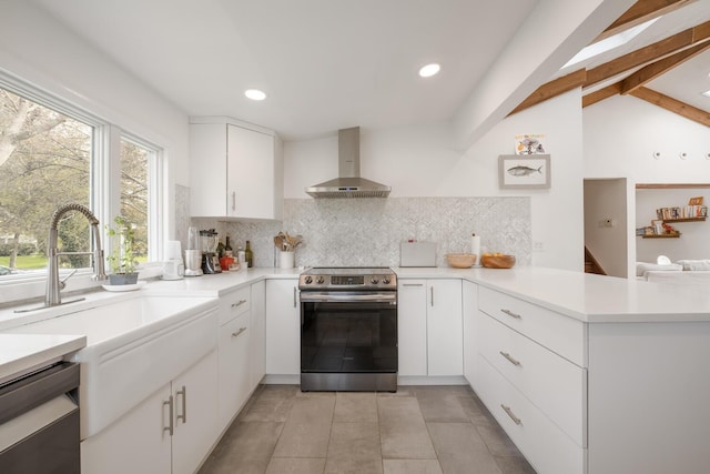35 Turtle Cove Ln, Huntington, NY 11743 - kitchen with stainless steel appliances, wall chimney exhaust hood, a peninsula, decorative backsplash, and light countertops