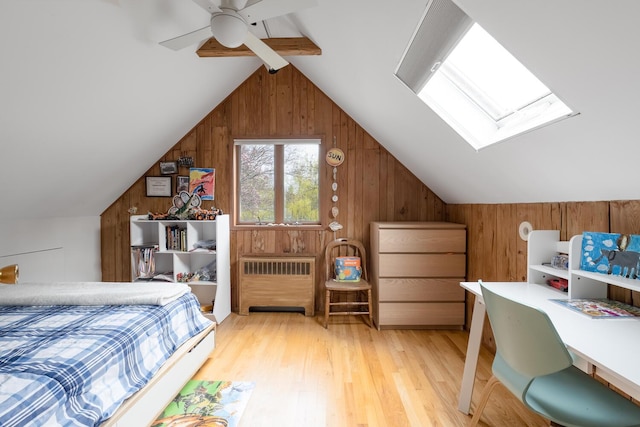 35 Turtle Cove Ln, Huntington, NY 11743 - bedroom featuring radiator heating unit, wooden walls, vaulted ceiling, light wood-style floors, and a skylight