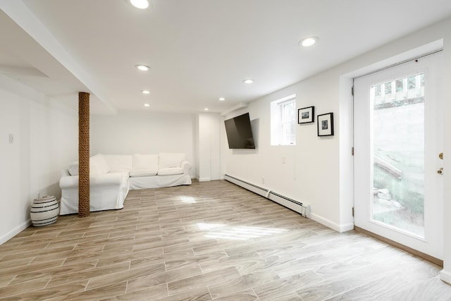 35 Turtle Cove Ln, Huntington, NY 11743 - basement with a baseboard radiator, recessed lighting, and light wood-type flooring