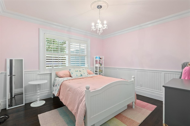 bedroom featuring wainscoting, dark wood-style floors, crown molding, and a chandelier