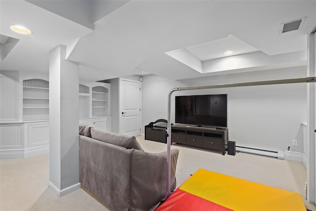 carpeted living room featuring a baseboard radiator, built in features, and baseboards