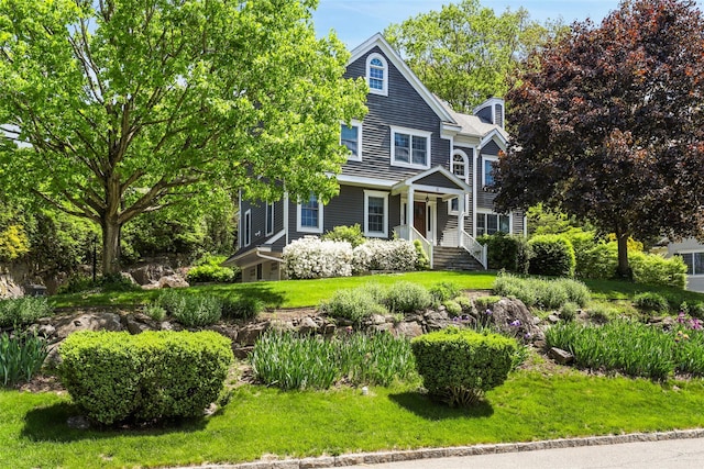 view of front facade with a chimney and a front yard