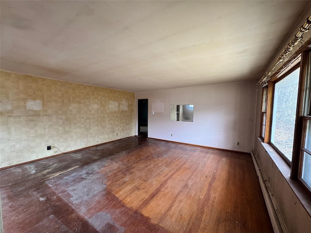 spare room with wood finished floors and baseboards