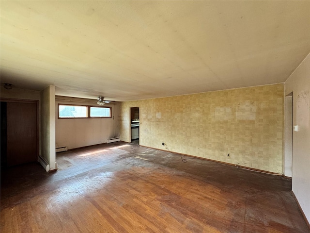 unfurnished living room with a baseboard heating unit, a ceiling fan, dark wood-style flooring, and baseboard heating