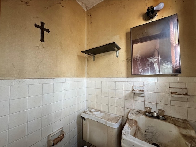 bathroom with wainscoting and toilet