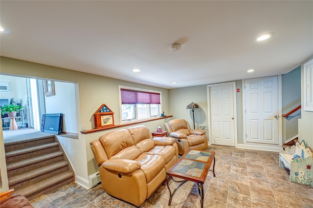 living room featuring stairway, baseboards, stone finish flooring, and recessed lighting