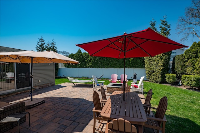 view of patio featuring outdoor dining area and fence
