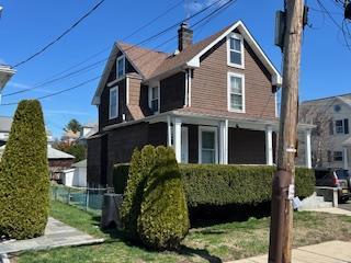 30 Treno St, New Rochelle, NY 10801 - view of property exterior with a chimney, a garage, and fence