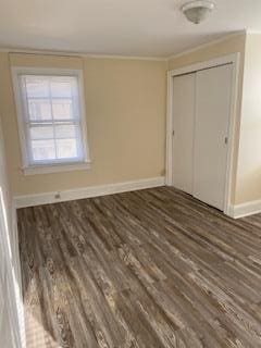 30 Treno St, New Rochelle, NY 10801 - unfurnished bedroom with crown molding, a closet, baseboards, and wood finished floors