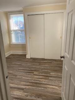 30 Treno St, New Rochelle, NY 10801 - unfurnished bedroom featuring dark wood-type flooring, a closet, and baseboards