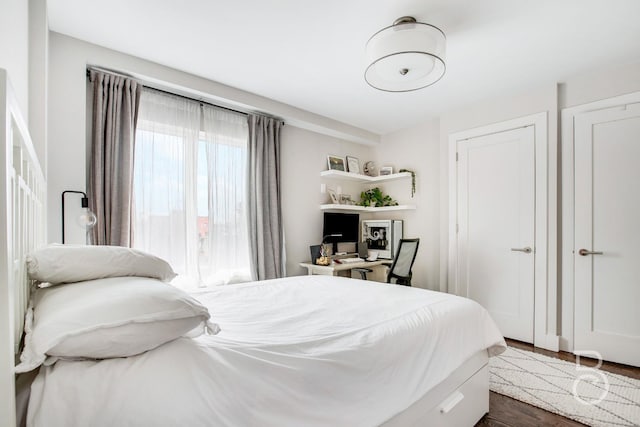 bedroom with dark wood-type flooring