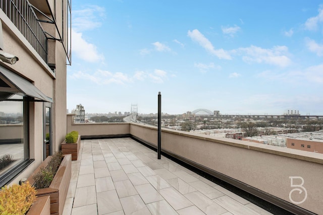 view of patio / terrace featuring a view of city and a balcony