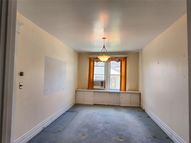unfurnished dining area featuring carpet floors, baseboards, and cooling unit