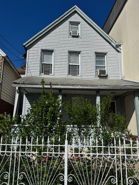 101-14 95th St, Ozone Park, NY 11416 - view of front of house featuring covered porch, cooling unit, and fence
