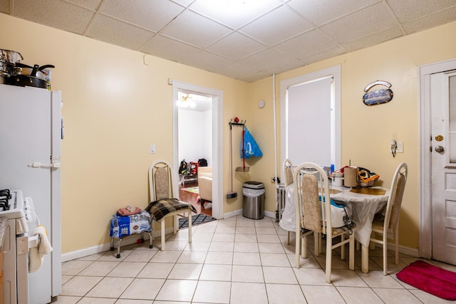 101-14 95th St, Ozone Park, NY 11416 - dining space featuring a drop ceiling, baseboards, and light tile patterned floors