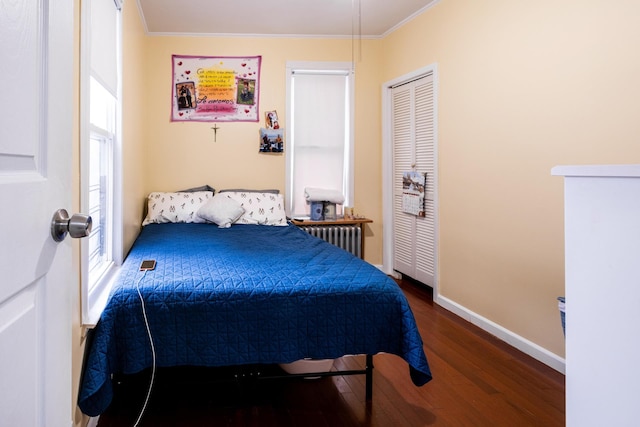 101-14 95th St, Ozone Park, NY 11416 - bedroom featuring radiator heating unit, ornamental molding, wood finished floors, baseboards, and a closet