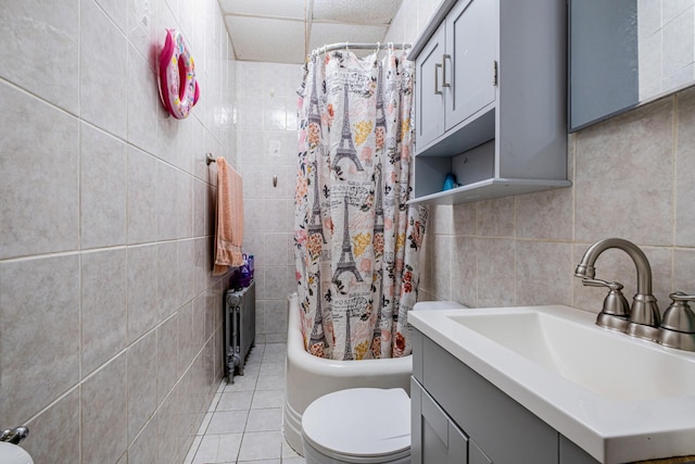 101-14 95th St, Ozone Park, NY 11416 - bathroom with tile walls, toilet, vanity, shower / tub combo, and tile patterned floors