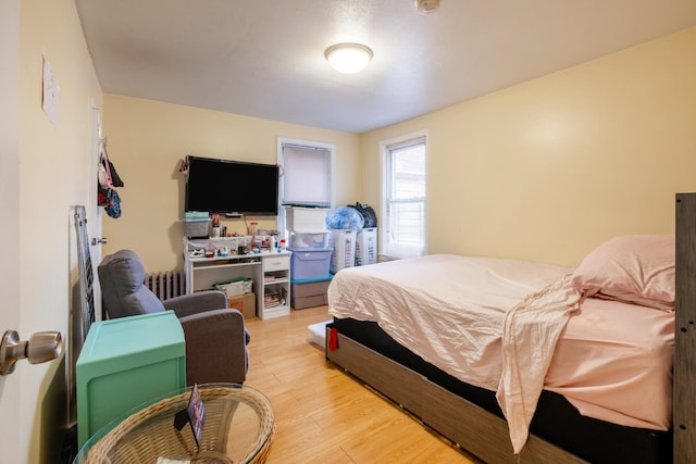 101-14 95th St, Ozone Park, NY 11416 - bedroom with light wood-style flooring and radiator heating unit