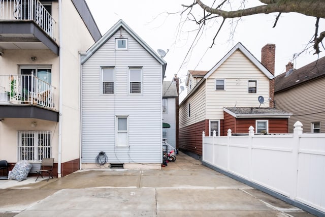 101-14 95th St, Ozone Park, NY 11416 - back of house with fence, a balcony, and a patio