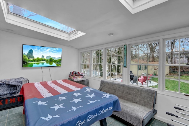 tiled bedroom with a skylight and multiple windows