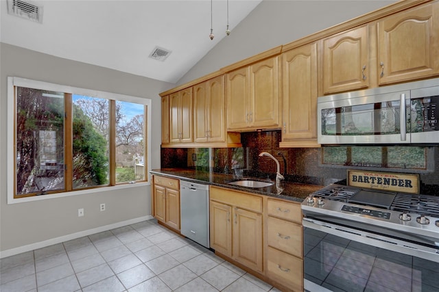 kitchen with vaulted ceiling, backsplash, visible vents, appliances with stainless steel finishes, and a sink