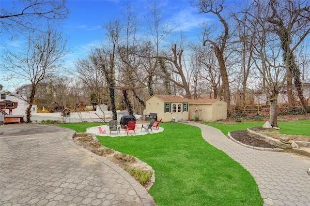 view of yard featuring a patio, an outdoor structure, and fence