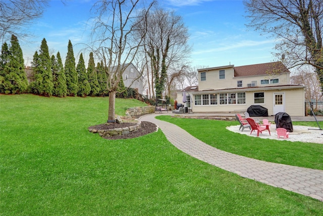 view of yard featuring an outdoor fire pit, a patio, and fence